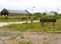 Part of the once extensive yards at Stranraer Town, seen here abandoned in May 2007. The building on the left is the former locomotive shed, while in the right background is the main stand at Stair Park, home of Stranraer FC. View is east, with the remains of Stranraer Town station behind the camera [see image 15443].  <br><br>[John Furnevel 31/05/2007]