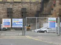 Construction site fencing and signage seen in the former car park area at the end of April 2017. The temporary ramp giving access to platform 7, which was used during last year's platform lengthening and track realignment works, has already been removed.<br>
Demolition of the disused buildings at the east side of the station [see image 58827] is due to commence shortly. <br><br>[Colin McDonald 28/04/2017]