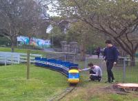 A miniature HST driven by a lawnmower engine receives an extraordinary transmission examination before the start of the day's services at the Little Western Railway adjacent to Newquay Zoo. The main line into Newquay station [see image 49638] can be seen in the background.<br><br>[Ken Strachan 12/04/2017]