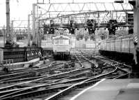 Arriving and departing class 86 electric locomotives hauling WCML long distance services pass just outside Glasgow Central station in the summer of 1981.<br><br>[John Furnevel 18/08/1981]