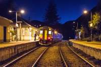 The guard checks for passengers as the final westbound train of the day pauses at Glenfinnan. The view is from the east end barrow crossing.<br><br>[Ewan Crawford 04/05/2017]