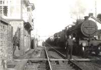 The Girvan Goods at Dunragit on 16 July 1956. Stranraer 2P 4-4-0 40616 pilots Corkerhill based Standard class 5 4-6-0 73100.<br><br>[G H Robin collection by courtesy of the Mitchell Library, Glasgow 16/07/1956]