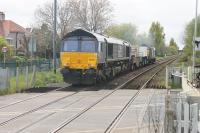 The Heysham flask trains are usually hauled by <I>Classic</I> traction. However, DRS 66301 was on the rear of the train from Sellafield on 28th April 2017 (lead loco 37259) as it passed over Bare Lane level crossing and would lead the return trip with the load for reprocessing. <br><br>[Mark Bartlett 28/04/2017]