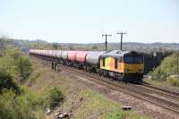 Vegetation clearance for the overheads has opened up  locations not available for years, but not for long. With the encroaching masts in the distance 60076, with the Dalston - Grangemouth empties, crosses Broomhill Road overbridge east of Greenhill on 5th May 2017.<br><br>[Douglas McPherson 05/05/2017]