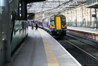 ScotRail 380002, forming the 1142 to North Berwick, waiting to board at Waverley platform 19 on 24 March 2017. <br><br>[John Furnevel 24/03/2017]