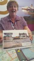 The old Balloch Central closed in 1986 is now operated by Visit Scotland as a tourist information centre. In this picture Caroline is showing a photo of how things used to look, with a view of <i>Maid of the Loch</i> in the background.<br><br>[John Yellowlees 09/05/2017]