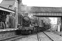 6990 <i>Witherslack Hall</i> heading a non-stop ballast train through Quorn.<br><br>[Peter Todd 06/05/2017]