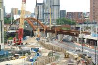 Looking south west from near Salford Central station on 19 May 2017 across the site of the new Ordsall Chord. Since my last visit the large brown girders are now almost complete over Trinity Way with only a short section to be fitted before reaching the new bridge over the River Irwell. [See image 56746] for a view from the same location 8 months earlier.<br><br>[John McIntyre 19/05/2017]