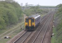 150204, forming a Manchester Victoria to Blackpool North service, passes Bradkirk on 6th May 2017. Mast bases have been dropped off either side of the running lines in preparation for electrification. To the left of the train remnants of the Marton line to Blackpool Central (closed 1964) can be seen diverging at this point, plus of course the famous Tower above the bridge.<br><br>[Mark Bartlett 06/05/2017]