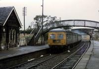 A Swindon Class 126 DMU passes through Dunlop on a very wet 19th June 1974. The DMU is heading south on the former northbound track. Single line working had been implemented pending the lifting and relaying of the nearer track, which ultimately would be the remaining track until recent re-doubling. (Comment from Michael Laing; That's a Class 126 inter-city DMU. Note the headcode panels, white circle MU code and buckeye coupler.)<br>
<br><br>[Colin Miller 19/06/1974]