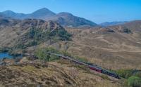 Under a blazing sun the Jacobite rounds the west end of Loch Eilt not far east of Lochailort station.<br><br>[Ewan Crawford 02/05/2017]