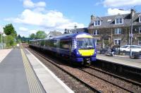 A through service to Glasgow pulls into Platform 1 at Dunblane while the ex-Edinburgh train waits in the reversing stub to replace it and return to the capital. The Edinburgh train had arrived in Platform 3 (left). These manoeuvres may seem a little unnecessary when Platform 3 is off the main line, but the<br>
Platform 3 track has no southbound connection with the up line. Platform 1<br>
is also more accessible for passengers.<br>
<br><br>[David Panton 18/05/2017]