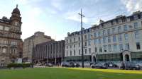 The frontage of Queen Street station on George Square with the Millenium Hotel (older than the railway, it was the Queen's Hotel, then the North British Hotel) to the right. The statue to the left is of Robert Peel, Prime Minister from 1834-35 and 1841-46, and was erected in 1859. He was a supporter of Free Trade, repealing the Corn Laws.<br><br>[Beth Crawford 18/05/2017]