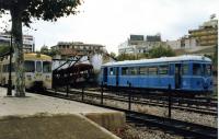 The low point, quite literally, of Majorcan Railways. This is Palma station in 1991, when the once extensive island network had been reduced to the tourist line to Soller and the 26km <I>main line</I> to Inca. The metre gauge diesel railcar on the left shuttled between Inca and Palma but other lines beyond Inca had been closed. The burnt out depot and railcar in the background summed it up really. Thankfully, since then, the line has been extended beyond Inca, electrified and also now terminates in an underground station in Palma connecting into the new Metro services. Soller services still run but from their own separate surface station.<br><br>[Mark Bartlett 05/10/1991]