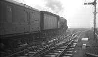 The 1.40pm service to Edinburgh via the Waverley route leaves Carlisle platform 7 on a foggy 22 December 1962. The train is hauled by A3 Pacific 60097 <I>Humorist</I>. [See image 42709]<br><br>[K A Gray 22/12/1962]