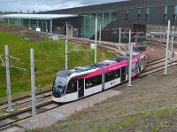 Tram 251 with promotional branding takes the sharp curve under the A8 as it leaves Edinburgh Gateway.<br><br>[Bill Roberton 21/05/2017]