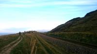 This is looking south, the line is from Boulby potash mine. Much of the output from the mine is transported by rail, as the site is located south of Loftus along the route of the former <a href=https://www.railscot.co.uk/Cleveland_Railway/>Cleveland Railway</a> and <a href=https://www.railscot.co.uk/Whitby_Redcar_and_Middlesbrough_Union_Railway/>Whitby Redcar and Middlesbrough Union Railway</a>. Today the line is open from  Saltburn to Boulby for goods traffic only. Teesport handles most of the bulk cargo export from the mine, via a specific potash and rock salt terminal.<br>
<br>
The <a href=http://www.nationaltrail.co.uk/cleveland-way target=external>Cleveland Way</a> is to the left.<br><br>[Alan Cormack 08/05/2017]