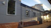 The somewhat less than attractive building adorning the platform at Dalmuir, as viewed from a westbound train.<br><br>[Beth Crawford 18/05/2017]