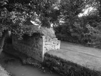 Halbeath Waggonway bridge abutment by the Mowbray Burn, seen from the Kingseat Road south of Halbeath level crossing in 1987, 120 years after closure. In 2017 this structure is no longer visible and has perhaps been removed. The location is just south of the site of the Halbeath Colliery. The location is marked 'Clarkston' on this <a href=http://maps.nls.uk/view/82882161 target=external>NLS map</a>.<br>
<br><br>[Bill Roberton //1987]