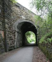 The substantial skew bridge carrying a minor road over the trackbed of the Penicuik Railway near the site of Eskbridge station (located some 150m further on). Photographed looking south towards the long closed Penicuik terminus on 19 May 2017, with the River North Esk just off picture to the right.<br><br>[John Furnevel 19/05/2017]
