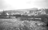 Ivatt 4MT 2-6-0 no 43049 undertaking shunting operations at Langholm during the Easter period in 1965. The building dominating the right background is Waverley Mill.<br><br>[Bruce McCartney //1965]