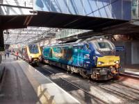 After bringing in commuters from Fife, Direct Rail Services 68 008 Avenger prepares to take the ECS off to Motherwell for the day, returning in the evening. Carbon neutral? A Virgin Voyager for Plymouth boards at Platform 19.<br><br>[David Panton 30/05/2017]