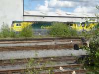 Looking across the sidings and running lines to the Freightliner TMD at Leeds Midland Road, with the two first built class 70s stabled at the eastern end of the long term stored loco line. 70002 is straight ahead, with the cab of 70001 to the right. [Ref query 1051]<br><br>[David Pesterfield 26/04/2017]