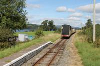 Summer lakeside scene on the Bala Lake Railway in 2016 as a train disappears towards Bala passing through Pentrepiod Halt. <br><br>[Mark Bartlett 17/09/2016]