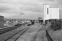 Looking north over Muir of Ord goods yard in 1990 with the temporary running shed on the left on the site of the goods shed. Looks like the Ness Viaduct collapse has done for the grain traffic. The former semaphore signals remained for a while after they became redundant.<br><br>[Bill Roberton //1990]