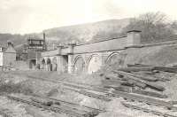 A general view of Bowling Swing Bridge from the south east on 12 April 1958, showing the approach arches and gantry mounted signal box. The lines in the foreground served the canal basin, off to the left.<br><br>[G H Robin collection by courtesy of the Mitchell Library, Glasgow 12/04/1958]