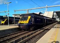 This down HST is literally and figuratively in the shadow of electrification at Reading. The Voyager in the background is a more modern express DMU.<br><br>[Ken Strachan 13/05/2017]