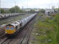 GBRf 66719 heads west, passing the Freightliner Midland Road TMD, with a loaded working from the recently rail connected Tarmac Arcow Quarry near Horton in Ribblesdale. The rake of wagons appear to be the new GBRf aggregates wagons created by shortening former bottom discharge coal wagons, by removing the centre hopper section, to make them more suitable for loading fully with the heavier aggregates. <br><br>[David Pesterfield 26/04/2017]