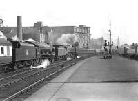 Looking out along the platform at St Enoch on 31 March 1954, as a through service to Newcastle Central prepares to depart. At the head of the train is Kingmoor 'Clan' Pacific 72009 <I>Clan Stewart</I>, piloting Polmadie 'Royal Scot' 4-6-0 46105 <I>Cameron Highlander</I><br><br>[G H Robin collection by courtesy of the Mitchell Library, Glasgow 31/03/1954]
