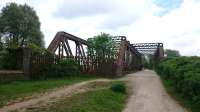 This substantial bridge crosses the River Avon, approximately one mile from Stratford upon Avon on the old line to Long Marston. One side is in use as part of the Greenway path but the other side has no decking.<br><br>[Alan Cormack 23/05/2017]