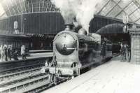 Ex-NBR D34 4-4-0 no 256 <I>Glen Douglas</I> in the process of backing onto the SLS <I>Scottish Rambler No 3</I> railtour at a sunny St Enoch station on 30 March 1964.<br><br>[G H Robin collection by courtesy of the Mitchell Library, Glasgow 30/03/1964]