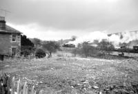 Shunting the pick up goods in the yard at Langholm in March 1965. The locomotive is Carlisle Kingmoor's Ivatt 4MT 2-6-0 no 43049, a regular visitor to the branch at that time.<br><br>[Bruce McCartney /03/1965]