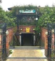 By contrast to the main entrance on the south side, the north entrance to Carrickfergus station is via a subway, seen here on 13 June 2017. The roof of the main building can be seen beyond the platforms.<br><br>[Andy Furnevel 13/06/2017]