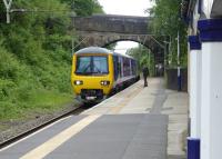 Northern 323238 approaches Hadfield on 16th June 2017 with a service that will quickly return to Piccadilly via Glossop. In the foreground a <I>Harrington Hump</I> can be seen providing level access to the 323 EMUs from Hadfield's surviving platform.<br><br>[Mark Bartlett 19/06/2017]
