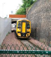 The 0924 ex-Edinburgh on the approach to Galashiels station passing below the A7 via what has become commonly referred to as 'Ladhope Tunnel'. The structure, an enhanced overbridge, has been the subject of much modification over the years [see image 49685].<br><br>[John Furnevel 16/06/2017]