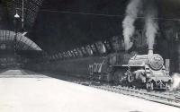 BR Standard class 3 2-6-0 no 77015 stands in the shadows at St Enoch on 11 July 1955 awaiting departure time with a train for Kilmarnock. The locomotive had been delivered new to Hurlford shed from Swindon Works the previous year.<br><br>[G H Robin collection by courtesy of the Mitchell Library, Glasgow 11/07/1955]