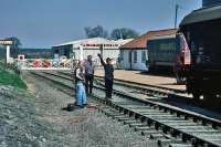 Shunting of grain hoppers under way at North Elmham on 27th April 1984. The train loco (37 080) is setting back to position empty wagons alongside the granary silos before taking the loaded wagons forward. This traffic and the line to Dereham closed in January 1989.<br><br>[Mark Dufton 27/04/1984]