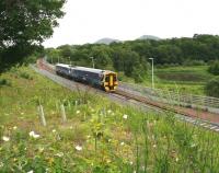 With the Eildon Hills forming the backdrop, an Edinburgh bound train on the Borders Railway comes off the Red Bridge over the River Tweed and runs past a meadow of wild flowers.  The attractive lochan on the right is part of Scottish Water's Galashiels sludge treatment works. (Sorry about that last bit)<br><br>[John Furnevel 16/06/2016]