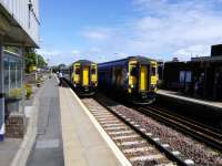 Full house at Barrhead with a stopping train for Glasgow in the bay, a<br>
non-stopper at Platform 2 and a Kilmarnock service pulling in to Platform 1.<br><br>[David Panton 17/06/2017]