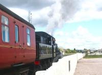 A train for Boat of Garten preparing to leave Aviemore on 14 May 2002. The SRS Aviemore Speyside station stands in the right background. Ivatt 2MT 2-6-0 no 46512 is at the head of the train.<br><br>[John Furnevel 14/05/2002]