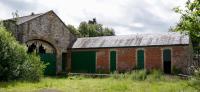 This building is often detailed as 'The Original station at Newtyle.' I am inclined to agree that the location of the 'Old' station is on the original site of the Dundee and Newtyle Railway at its northern terminus in Strathmore.<br>
<br>
If it is the original building, it does appear to have been very heavily modified. Some years ago I discovered on-line an illustration of an engraving which depicts the 'Railway Station at Newtyle.' This illustration was included in FORFARSHIRE ILLUSTRATED … a volume which was published by Gershom Cumming in Dundee in 1843. In this engraving the location, railway alignment and adjacent buildings are as we would expect them to be - the adjacent building still exist today. However the station building illustrated in the engraving appears to predate that which we know today suggesting the structure was either remodelled or re-built before the mid 19th century. John R Hume's, The Industrial Archaeology of Scotland : vol 2 [B.T.Batsford, London 1977] quotes the station to have been rebuilt - c 1836. Perhaps the Gershom Cumming engraving shows the terminus in its original state?<br>
The image is to be found here - <a href=http://www.gettyimages.co.uk/license/90781030 target=external>http://www.gettyimages.co.uk/license/90781030</a>. [Editor's note - it may have been re-built around the time of conversion to a goods shed, but can anyone shed any further light on this?]<br>
<br><br>[Colin Martin 24/06/2017]