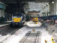 The west end of Waverley on the morning of 13 July 2017, looking towards the station concourse along platform 12. The building in the background will be removed to facilitate the platform extension [see image 59963]. On the left alongside platform 13 is ScotRail 334022 with the recently arrived 0826 service from Helensburgh Central.<br><br>[John Furnevel 13/07/2017]