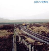 A laden Safeway train heads north at County March Summit roughly half way between Forsinard and Altnabreac.<br><br>[Ewan Crawford //]