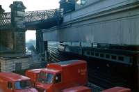 Looking east over the Royal Mail yard alongside Calton Road in 1985 as a southbound train prepares to leave platform 1. The Royal Mail depot at Waverley occupies the north east corner of the station just off to the right. Note the closed pedestrian footbridge which once linked Calton Road and Jeffrey Street [see image 9634].   <br><br>[John Furnevel 21/05/1985]