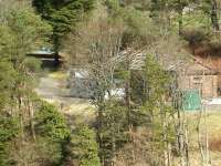 Victoria Lodge terminus and yard from the top of Talla dam in March 2004 - the end of the platform can be seen in the gap between the trees in the left background.<br><br>[John Furnevel 27/03/2004]