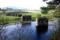 The surviving piers of Coulter Viaduct, photographed looking west across the River Clyde towards Symington in the autumn of 2004, with Coulter station off picture to the right. Tinto Hill stands in the left background.<br><br>[John Furnevel 28/11/2004]